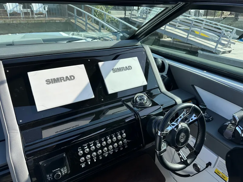 Slide: The Image of The cockpit of the 2021 Cruisers Yachts 38 GLS features a modern helm with Simrad displays. - 4