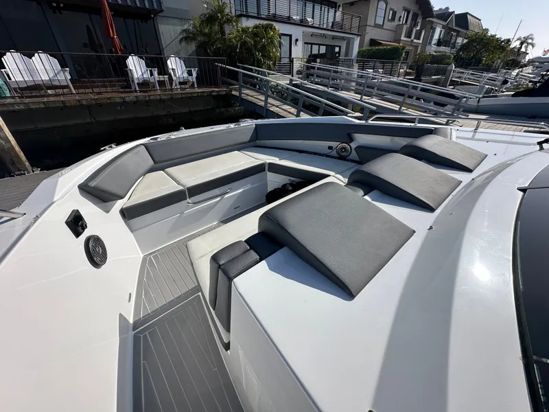 Slide: The Image of The image shows the bow area of a 2021 Cruisers Yachts 38 GLS with gray cushions and seating. - 43