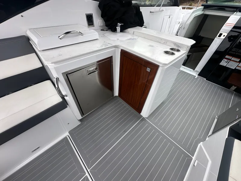 Slide: The Image of The 2021 Cruisers Yachts 38 GLS features a modern galley with stainless steel appliances and sleek finishes. - 26
