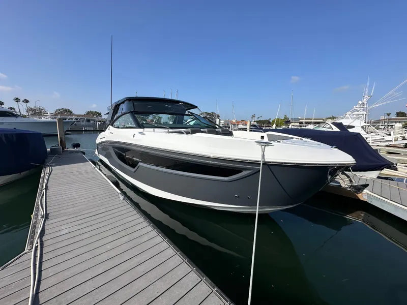 Slide: The Image of A 2021 Cruisers Yachts 38 GLS docked at a marina, with a sleek design and modern features. - 3