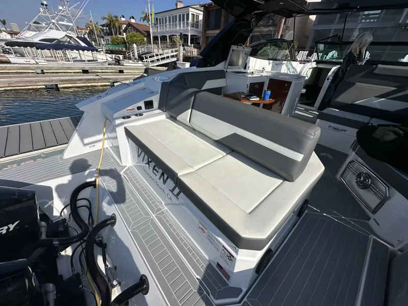 Slide: The Image of The image shows the cockpit of a 2021 Cruisers Yachts 38 GLS with gray upholstery and modern design. - 45