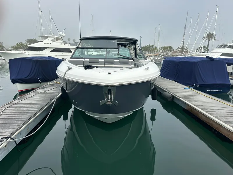 Slide: The Image of A 2021 Cruisers Yachts 38 GLS docked, surrounded by other boats. - 9