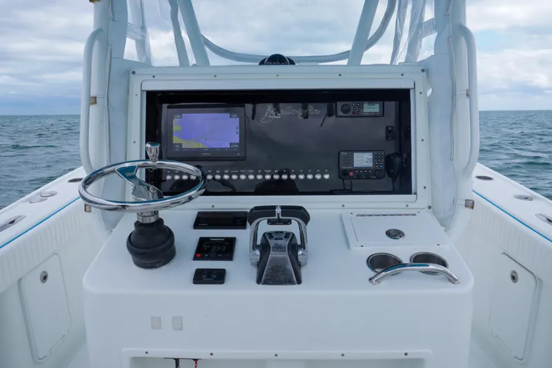 Slide: The Image of 2011 Yellowfin 32 Offshore boat console with navigation equipment and steering wheel. - 12