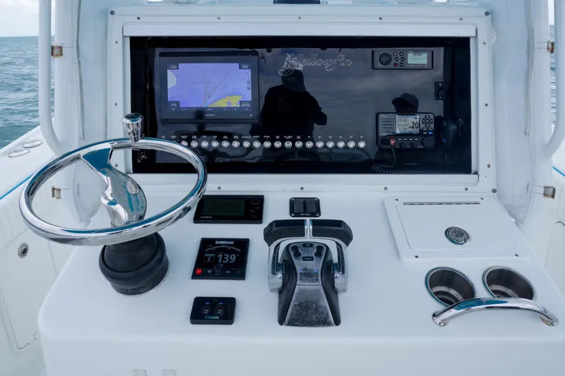 Slide: The Image of 2011 Yellowfin 32 Offshore boat dashboard with navigation and control systems. - 13