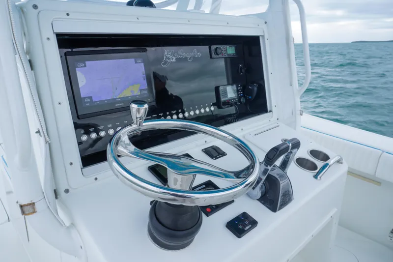Slide: The Image of 2011 Yellowfin 32 Offshore boat helm with navigation equipment and ocean view. - 14