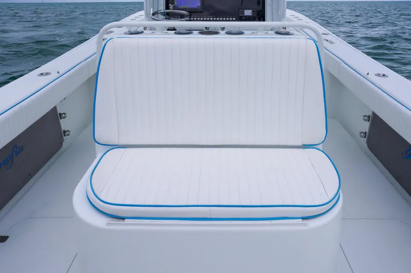 Slide: The Image of 2011 Yellowfin 32 Offshore boat interior with white cushioned seating. - 15