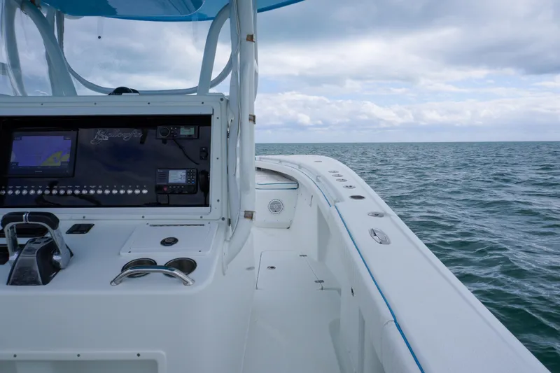 Slide: The Image of 2011 Yellowfin 32 Offshore boat dashboard with ocean view under cloudy sky. - 17