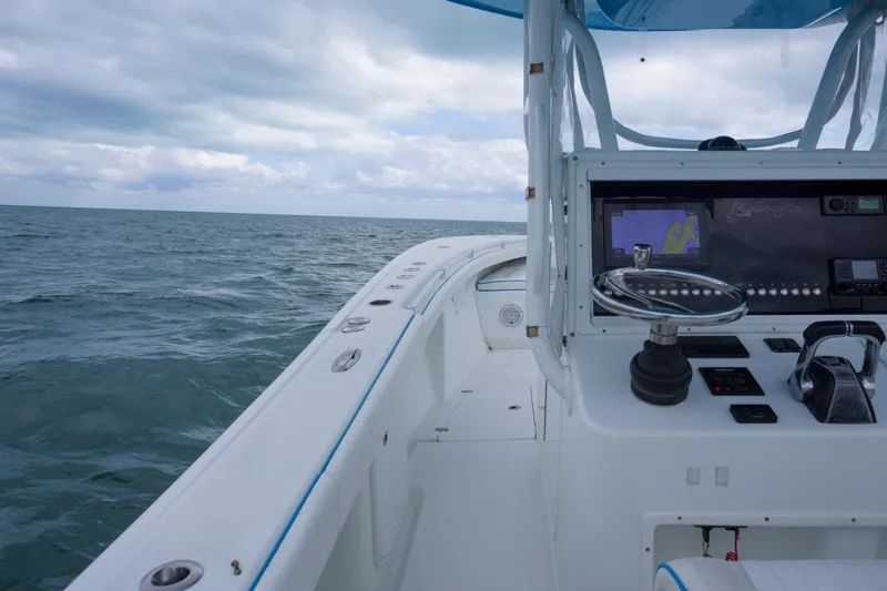 Slide: The Image of 2011 Yellowfin 32 Offshore boat dashboard with ocean view under cloudy sky. - 18