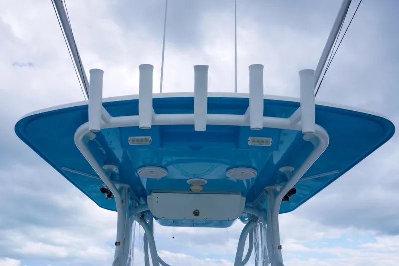 Slide: The Image of 2011 Yellowfin 32 Offshore boat's blue T-top against cloudy sky. - 19