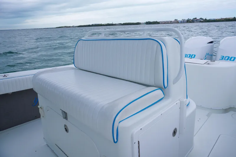 Slide: The Image of 2011 Yellowfin 32 Offshore boat with white seating and blue trim on open water. - 20