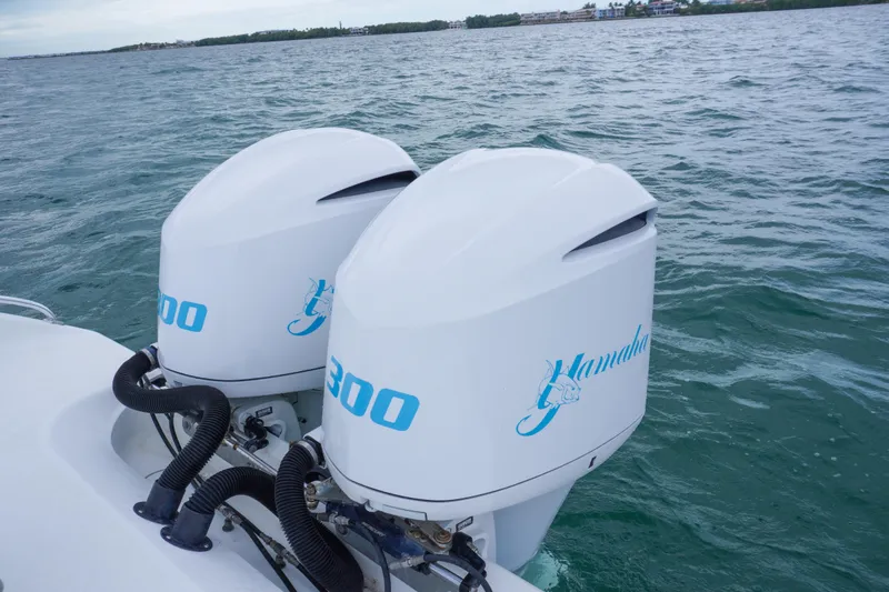 Slide: The Image of Twin outboard engines on a 2011 Yellowfin 32 Offshore boat in open water. - 24