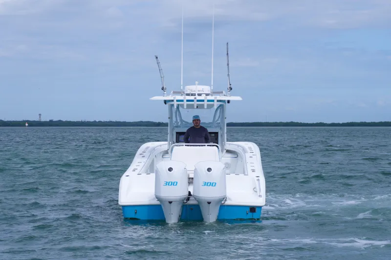 Slide: The Image of 2011 Yellowfin 32 Offshore boat on open water, twin 300 engines, clear sky. - 5