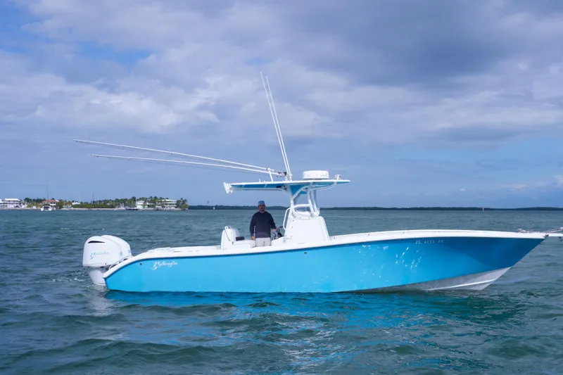 Slide: The Image of 2011 Yellowfin 32 Offshore boat on water, clear sky background. - 7