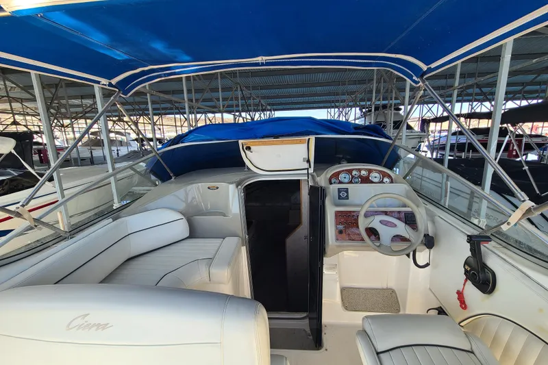 Slide: The Image of 1998 Bayliner 2855 Ciera Sunbridge interior with blue canopy and steering console. - 4