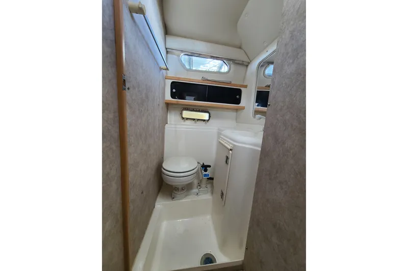 Slide: The Image of 1998 Bayliner 2855 Ciera Sunbridge bathroom interior with toilet and sink. - 6