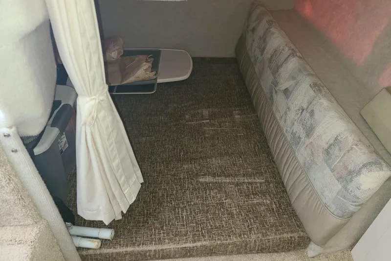 Slide: The Image of Interior cabin of 1998 Bayliner 2855 Ciera Sunbridge with seating and curtain. - 9