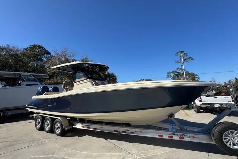 Slide: The Image of 2026 Chris-Craft Catalina 31 boat on trailer, parked outdoors under clear blue sky. - 10