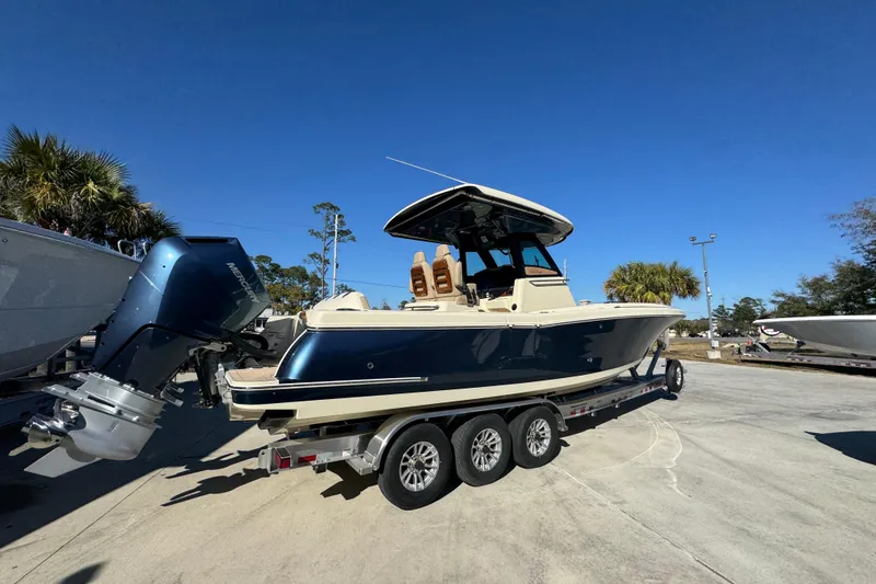 Slide: The Image of 2026 Chris-Craft Catalina 31 boat on trailer, featuring sleek design and powerful outboard motor. - 13