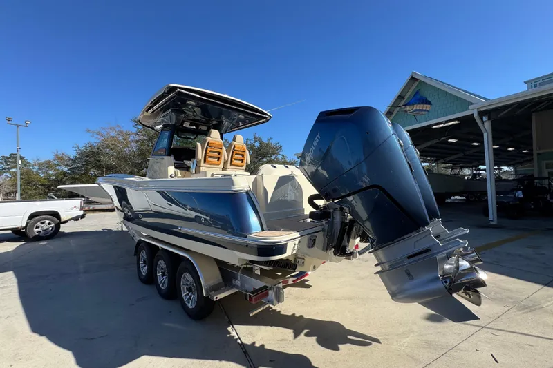 Slide: The Image of 2026 Chris-Craft Catalina 31 boat with powerful outboard engine on trailer. - 18