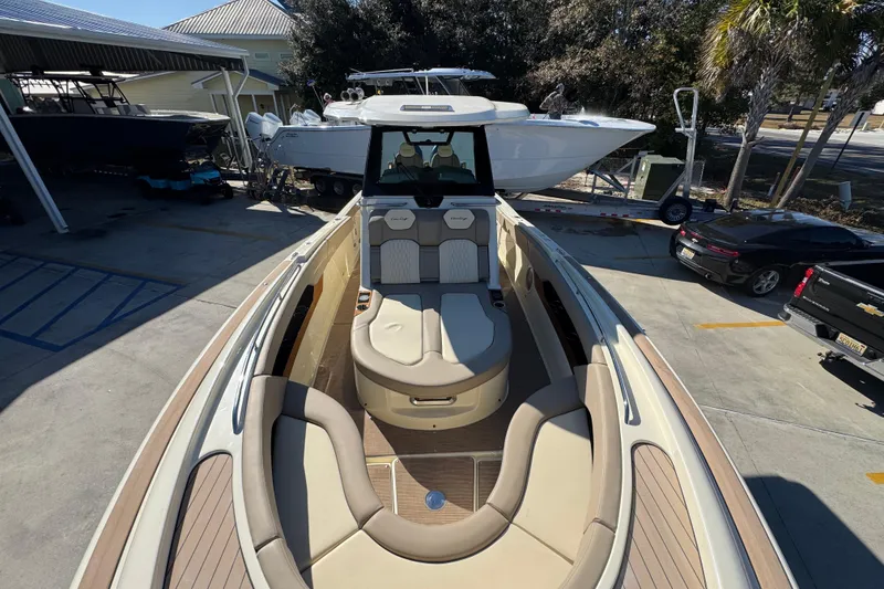 Slide: The Image of 2026 Chris-Craft Catalina 31 boat with luxurious seating, docked in a marina. - 22