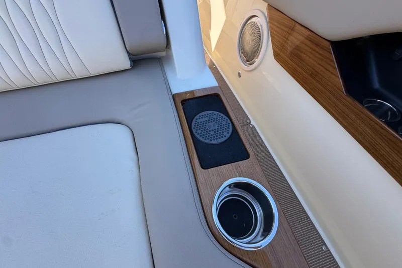 Slide: The Image of 2026 Chris-Craft Catalina 31 interior with speaker, cup holder, and cushioned seating. - 24