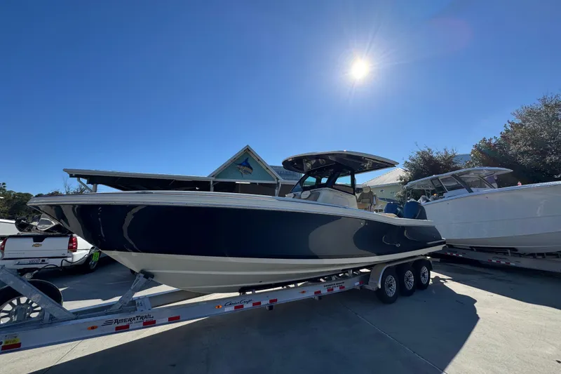 Slide: The Image of 2026 Chris-Craft Catalina 31 boat on trailer under bright sunlit sky. - 3
