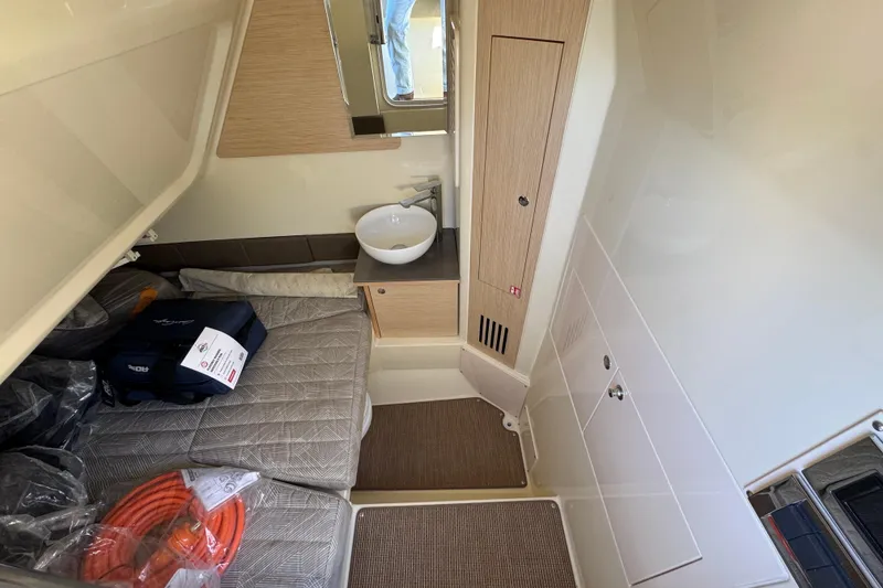 Slide: The Image of 2026 Chris-Craft Catalina 31 cabin interior with bed, sink, and storage. - 31