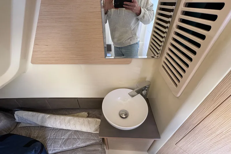 Slide: The Image of 2026 Chris-Craft Catalina 31 interior with modern sink and mirror in compact bathroom. - 33