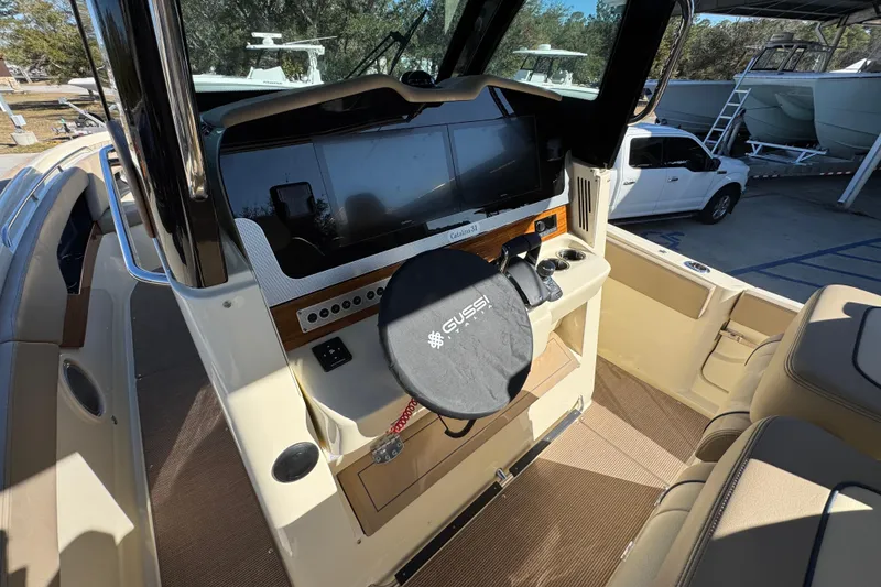 Slide: The Image of 2026 Chris-Craft Catalina 31 helm with modern controls and steering wheel cover. - 37