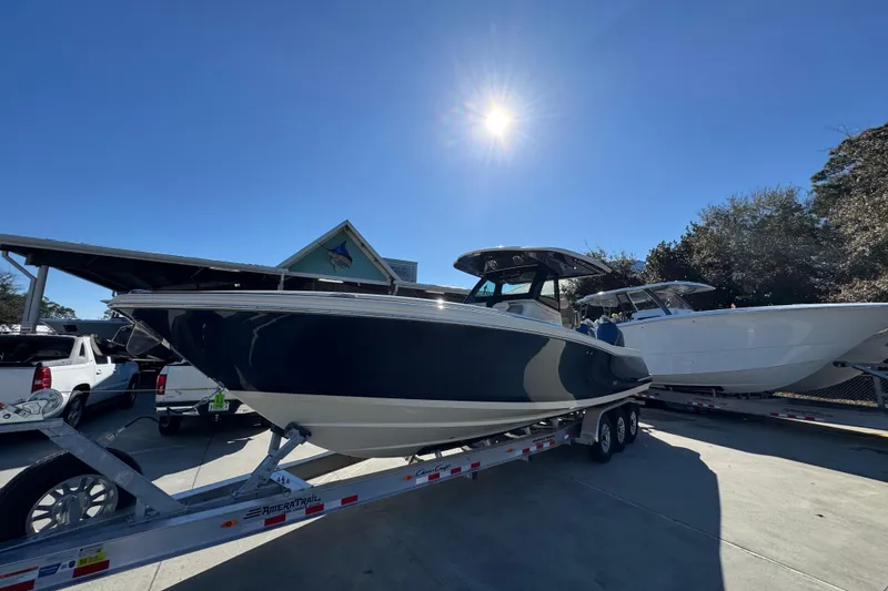Slide: The Image of 2026 Chris-Craft Catalina 31 boat on trailer under bright sun. - 4