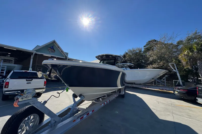Slide: The Image of 2026 Chris-Craft Catalina 31 boat on trailer under bright sun at dealership. - 5