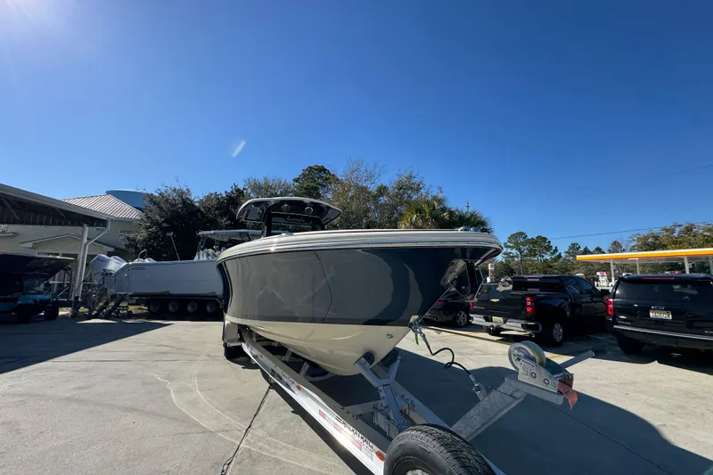 Slide: The Image of 2026 Chris-Craft Catalina 31 boat on trailer under clear blue sky. - 8