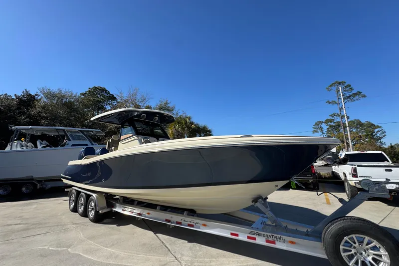 Slide: The Image of 2026 Chris-Craft Catalina 31 boat on trailer under clear blue sky. - 9