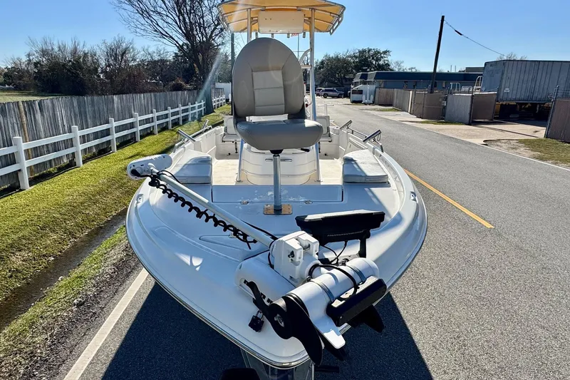 Slide: The Image of 2006 NauticStar 2200 NauticBay boat on road, featuring trolling motor and seating. - 5