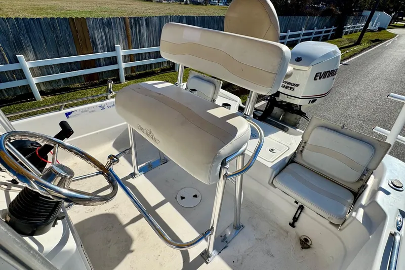 Slide: The Image of 2006 NauticStar 2200 NauticBay boat interior with steering wheel and Evinrude engine. - 8