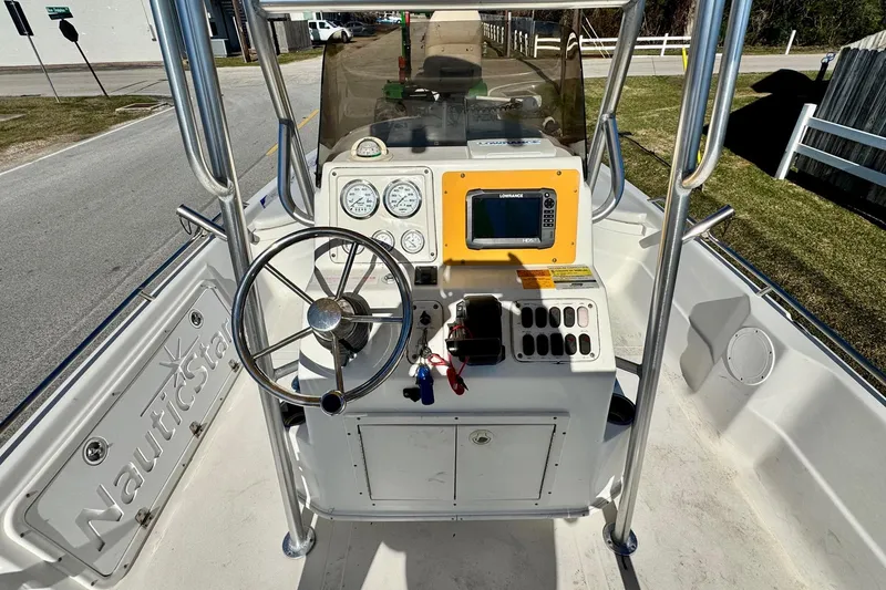 Slide: The Image of 2006 NauticStar 2200 NauticBay boat console with steering wheel and navigation equipment. - 9