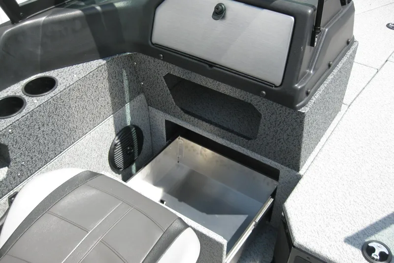 Slide: The Image of 2025 Lund 1875 Impact XS Sport boat interior with storage compartment and cup holders. - 13
