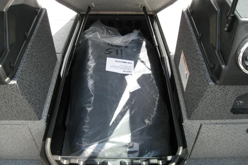 Slide: The Image of Storage compartment of 2025 Lund 1875 Impact XS Sport boat, featuring organized interior. - 15