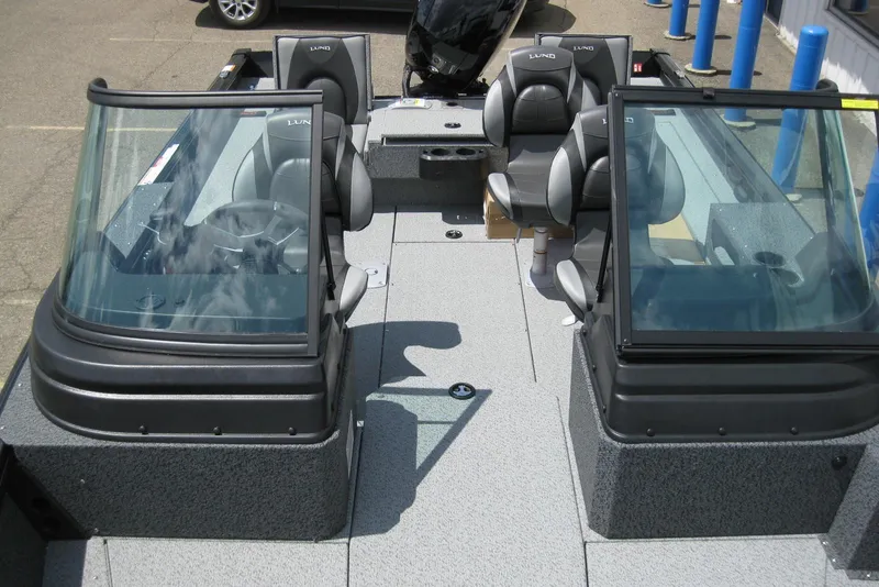 Slide: The Image of 2025 Lund 1875 Impact XS Sport boat interior with seating and windshield. - 17