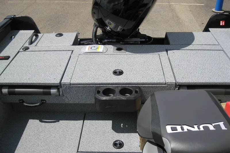 Slide: The Image of 2025 Lund 1875 Impact XS Sport boat interior with storage compartments and seating. - 8