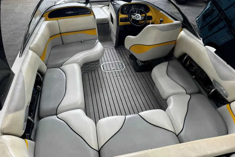 Slide: The Image of 2005 Malibu Wakesetter VLX interior with gray and yellow seating, sleek design, and spacious layout. - 11