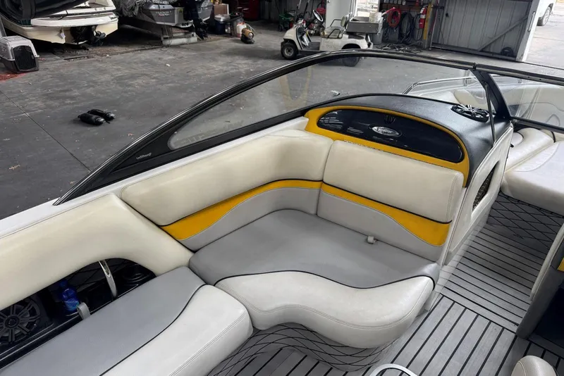 Slide: The Image of 2005 Malibu Wakesetter VLX interior with yellow and gray seating in a garage setting. - 12