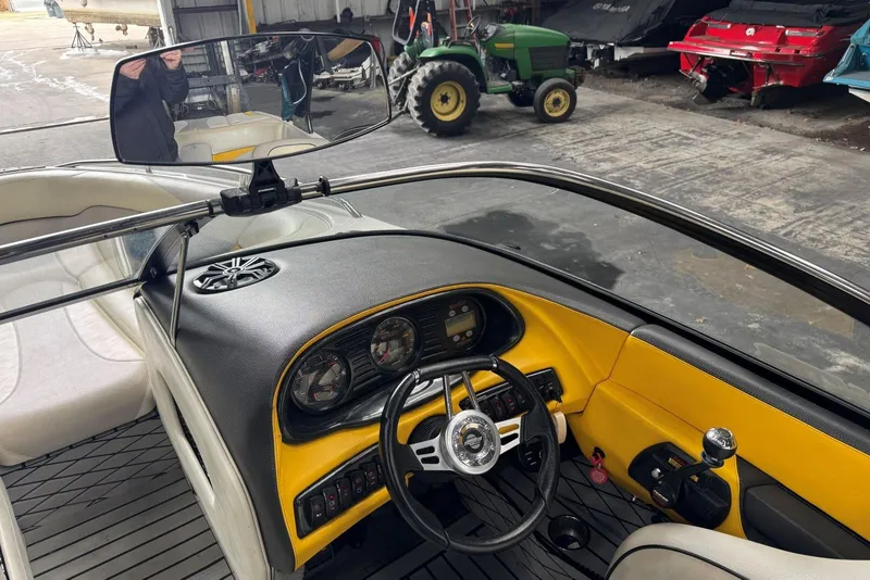 Slide: The Image of 2005 Malibu Wakesetter VLX interior with yellow dashboard and steering wheel in a garage setting. - 13