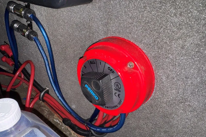 Slide: The Image of Red Perko battery switch in a 2005 Malibu Wakesetter VLX boat. - 26