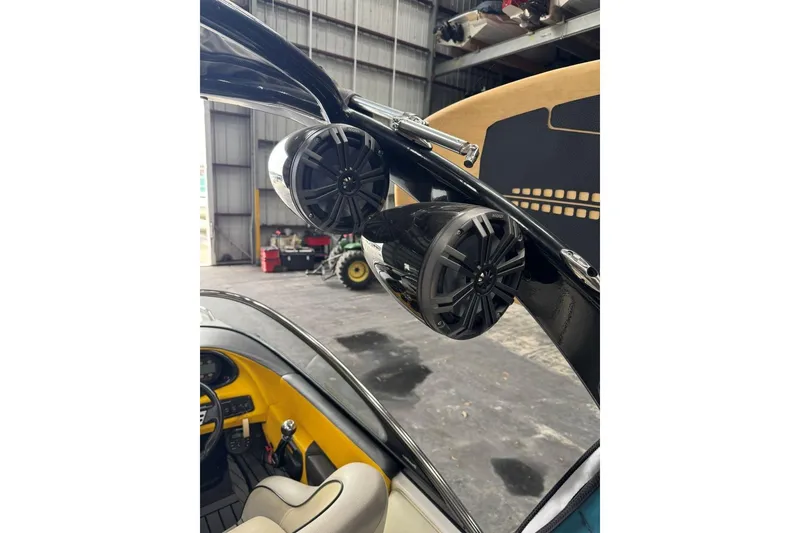 Slide: The Image of 2005 Malibu Wakesetter VLX boat with mounted speakers in a garage setting. - 28