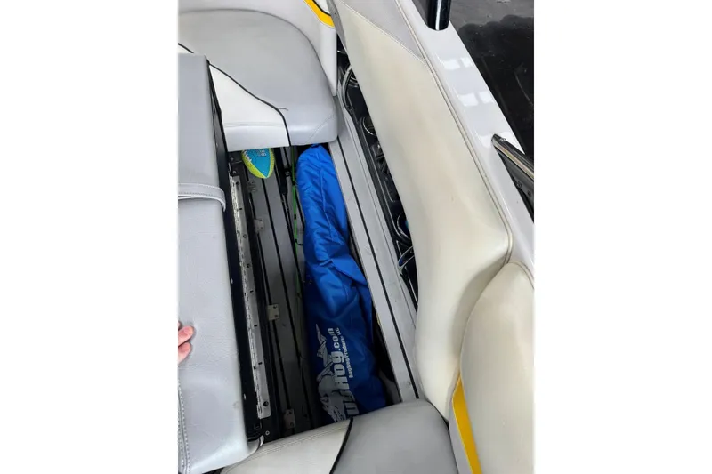 Slide: The Image of 2005 Malibu Wakesetter VLX interior storage compartment with blue cover and white seats. - 29