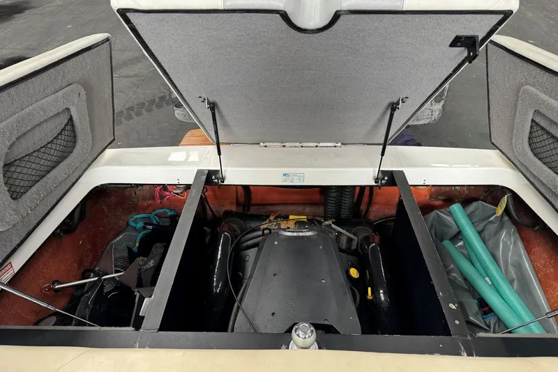Slide: The Image of Open engine compartment of a 2005 Malibu Wakesetter VLX boat, showing internal components. - 30