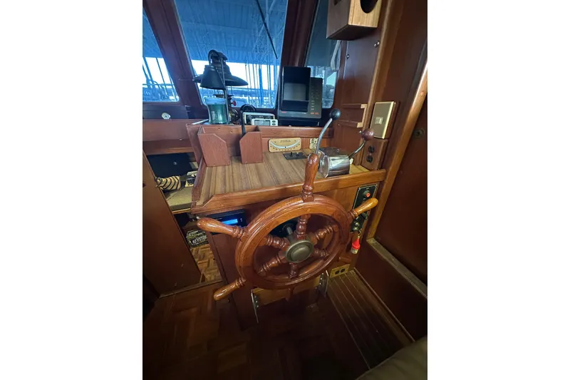 Slide: The Image of 1986 Present Yachts 35 MotorYacht helm with wooden wheel and navigation equipment. - 11