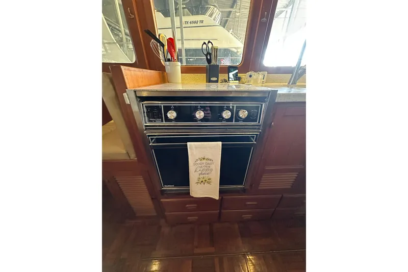 Slide: The Image of 1986 Present Yachts 35 MotorYacht kitchen with stove and utensils. - 15