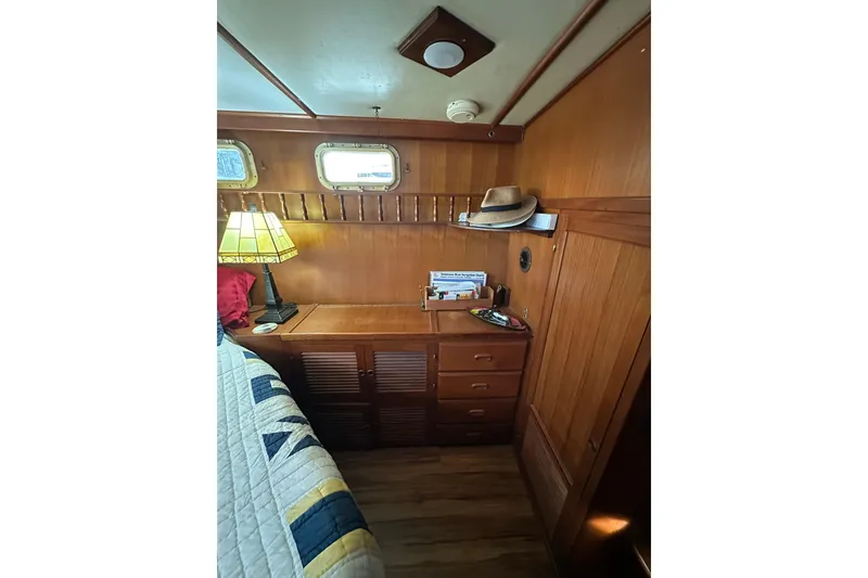 Slide: The Image of Cozy cabin interior of 1986 Present Yachts 35 MotorYacht with wooden furnishings and decor. - 22